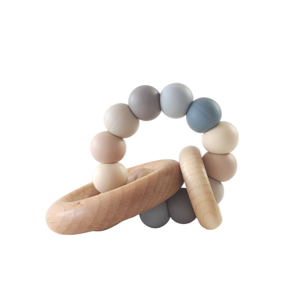 Wooden teething ring with multicolored beads on a white background