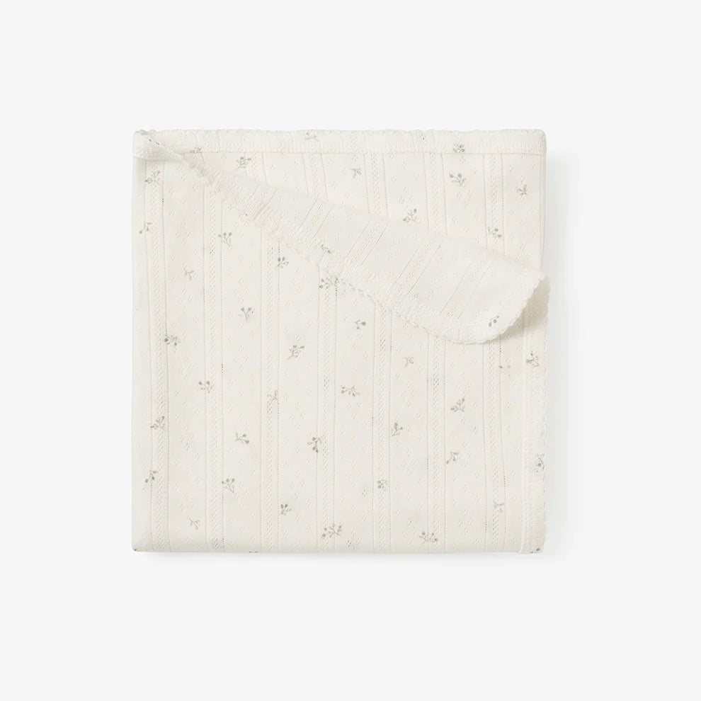 a white organic cotton pointelle blanket for babies.